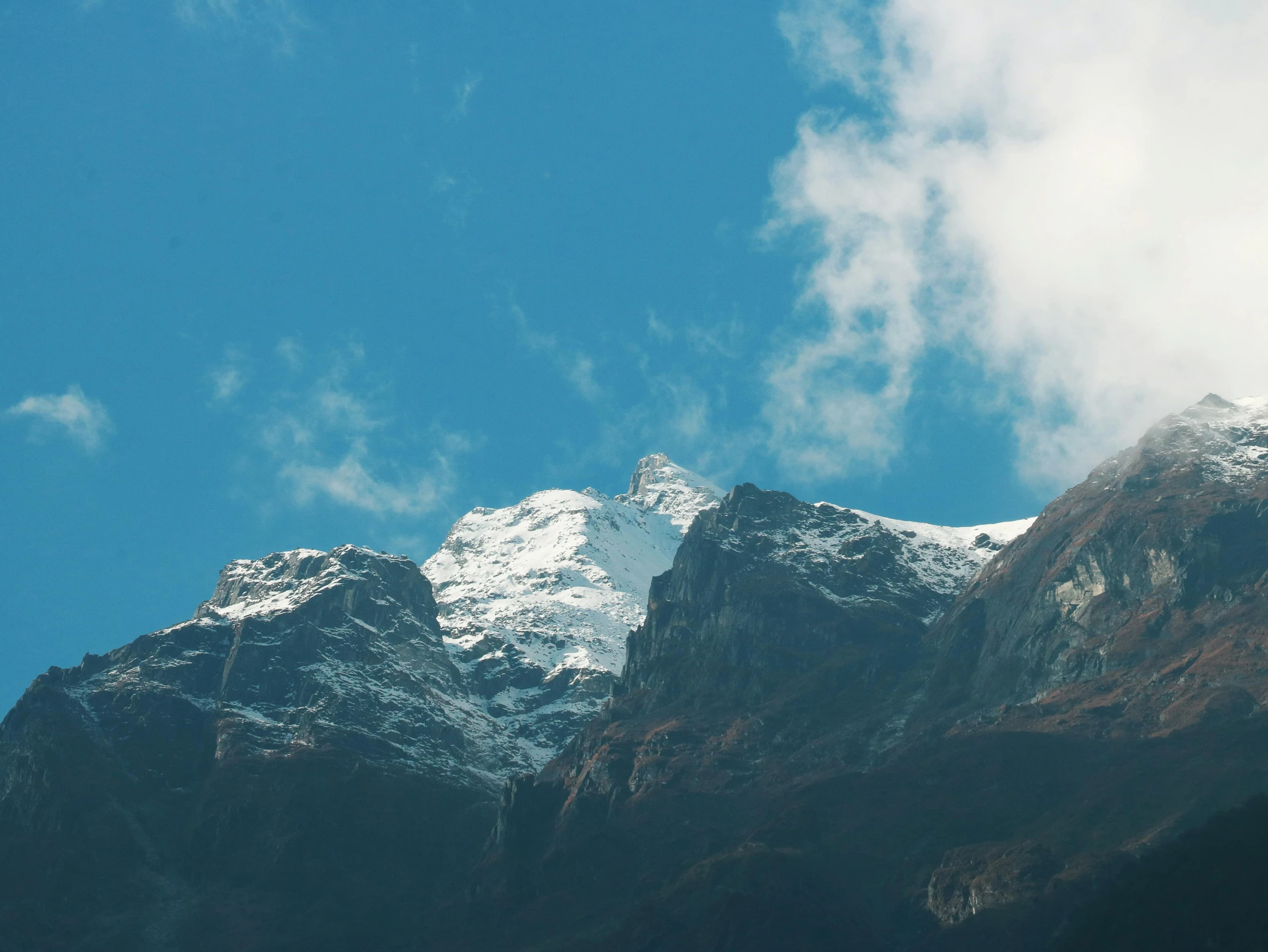 a snow covered mountain that has a clock on it