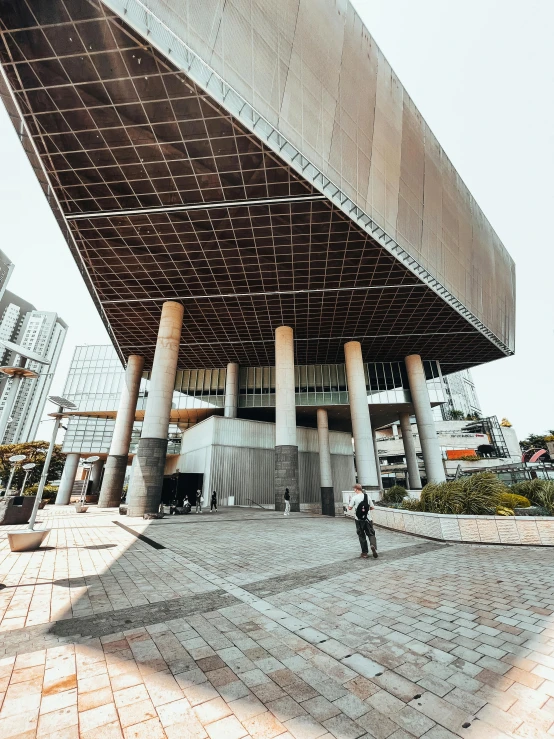 a person taking a po in front of an enormous building