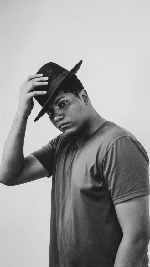 man wearing hat against white background with hat on his head