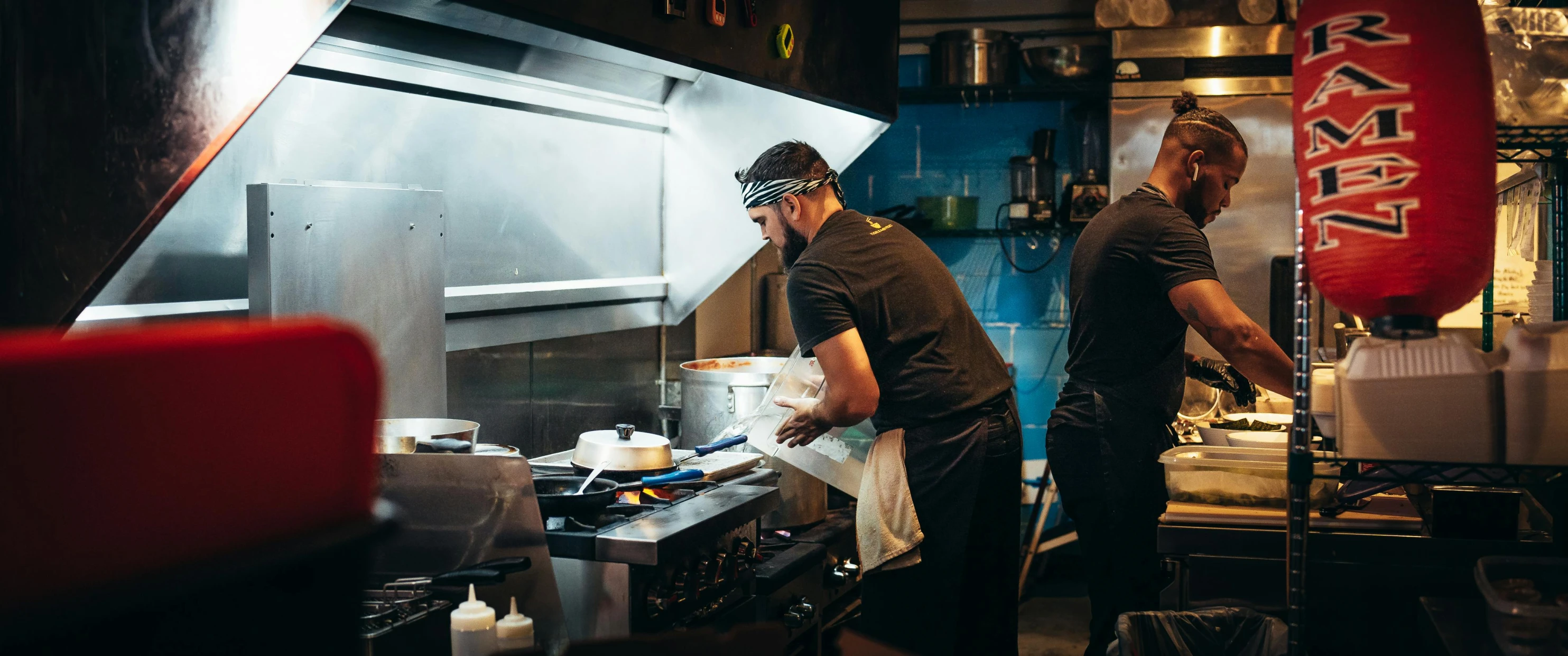 two people in a kitchen preparing food together