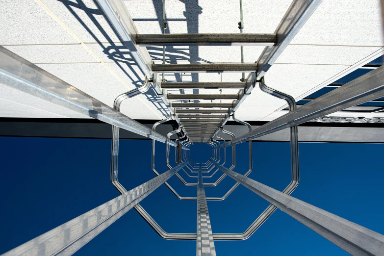 a view looking up into the sky from underneath a walkway