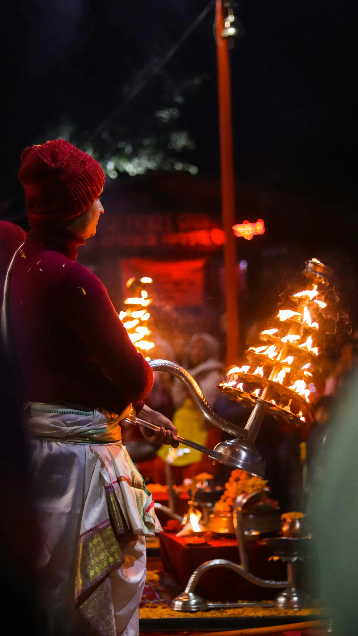 a person holding an indian food item in her hand