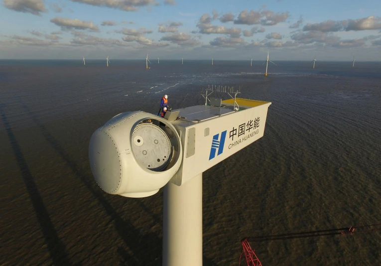 a large wind turbine sitting in the middle of a field