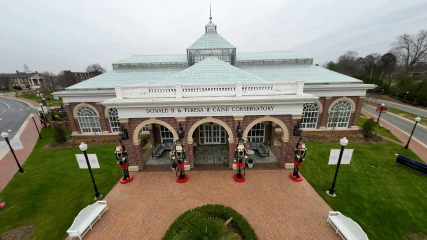 an aerial s of a building with statues in front of it