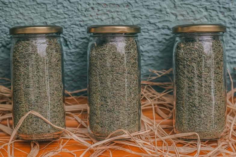 three jars with different stuff in them on a table