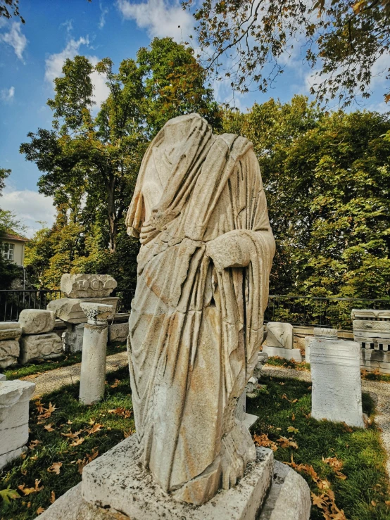 an old cemetery with many headstones and a statue in the foreground