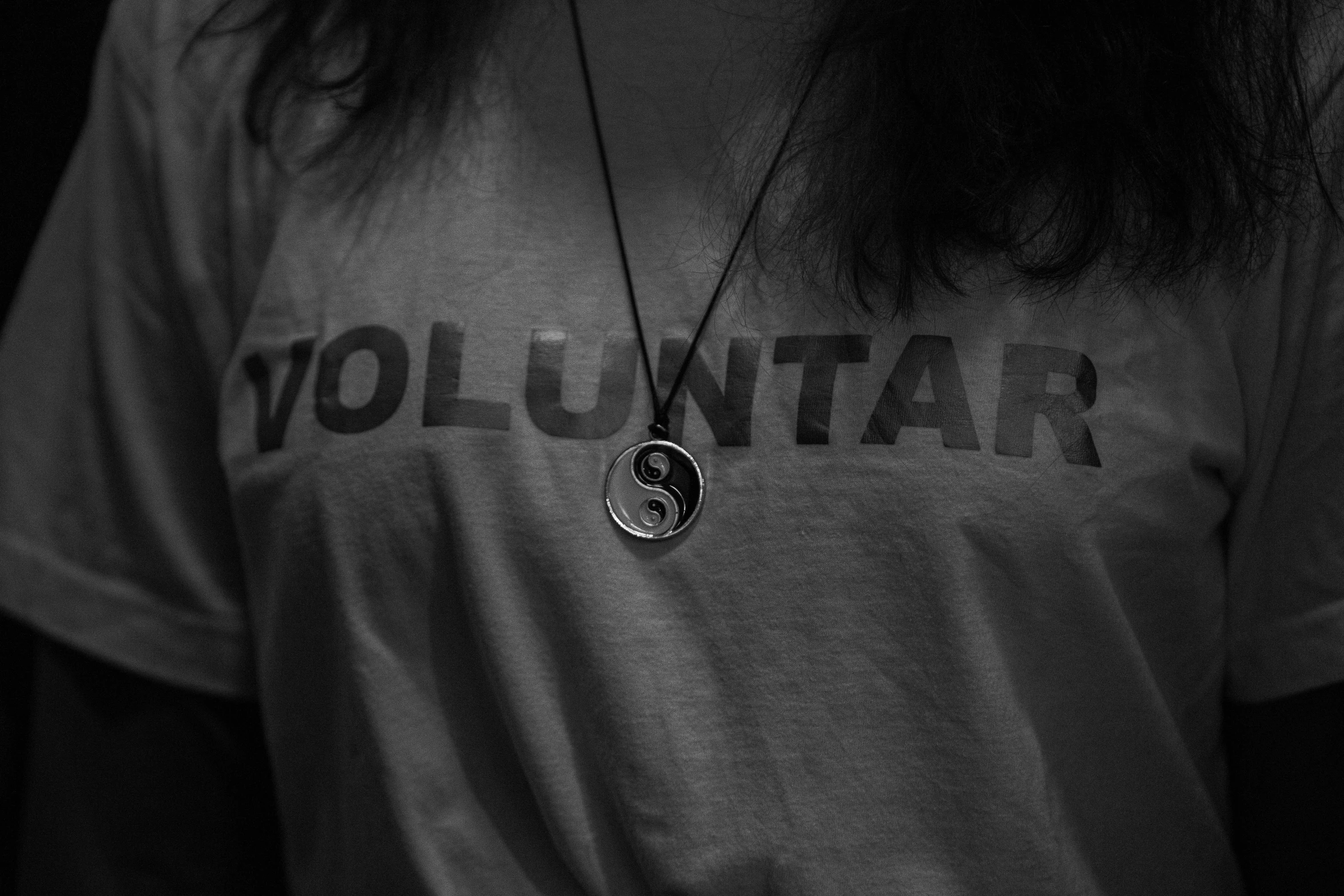 a close - up of a woman with long hair and a necklace