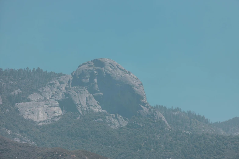 there are mountains in the background with trees on each side