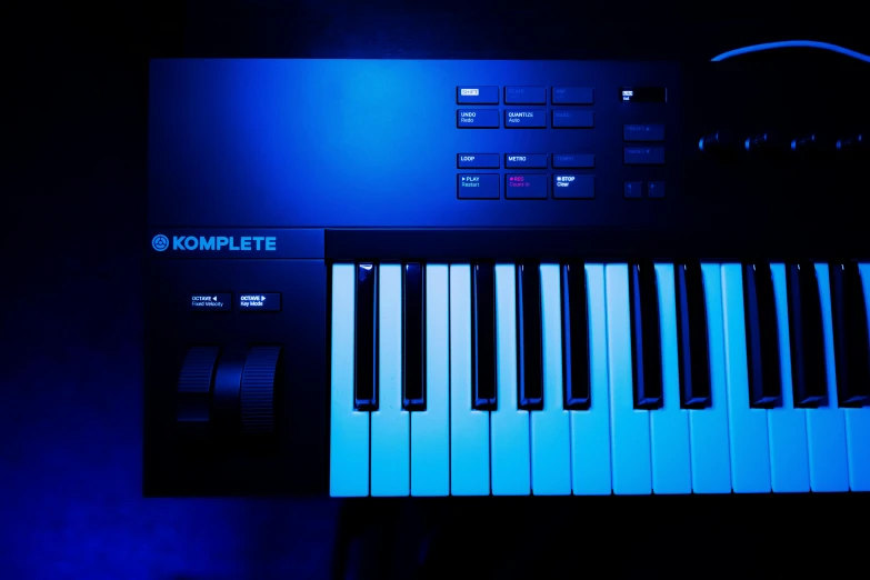 piano keys glow blue in the dark on a keyboard