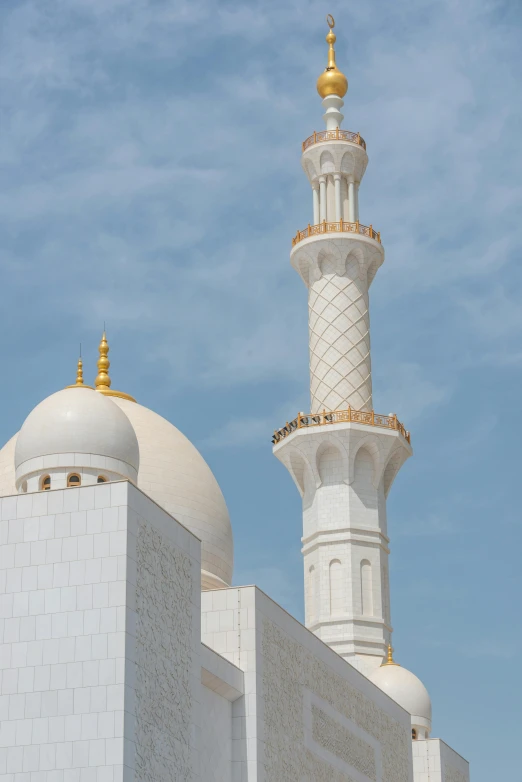 two white white domes and a gold dome atop each