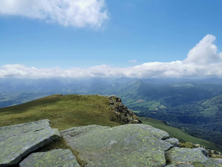 the mountains are in view, looking down from the summit