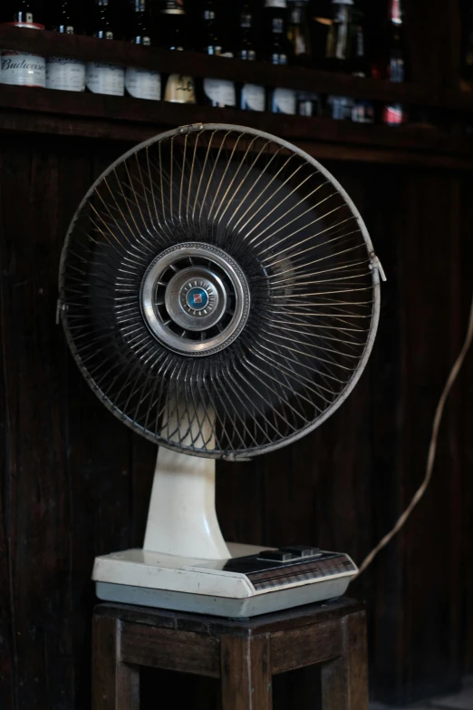 a white table top sitting under a fan on top of a table