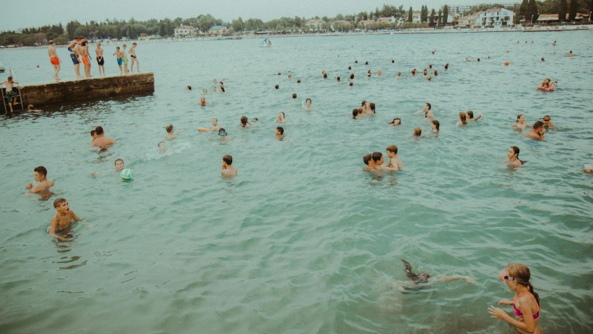 group of people swimming in ocean with s on