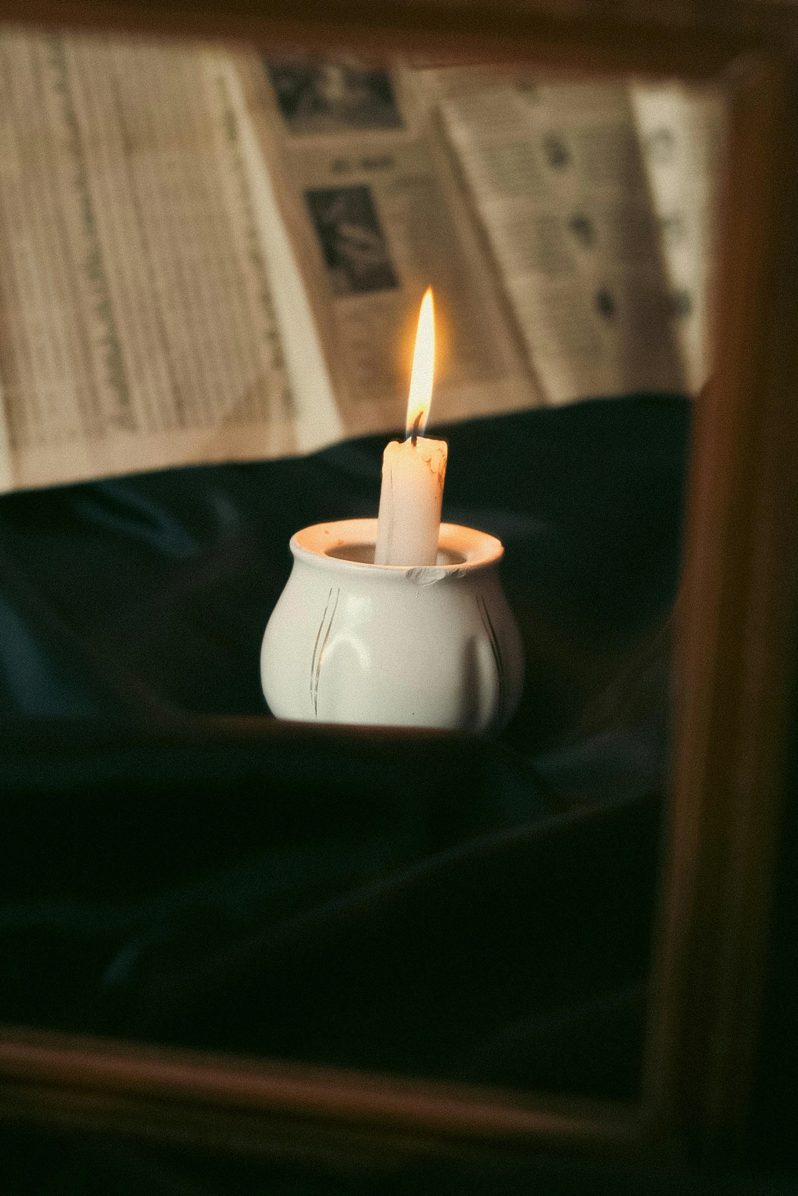 the small candle has been lit in the bowl