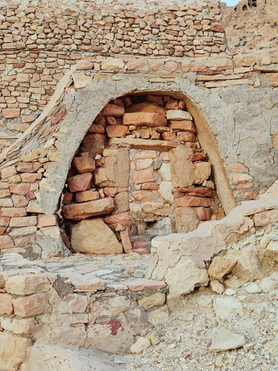 a large old structure with bricks that has been made into a small cave