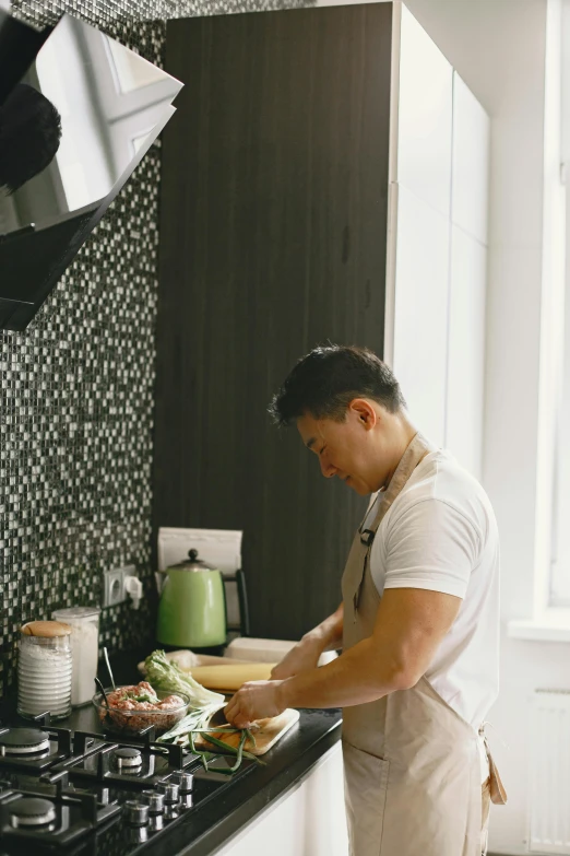 a man in an apron is making a salad