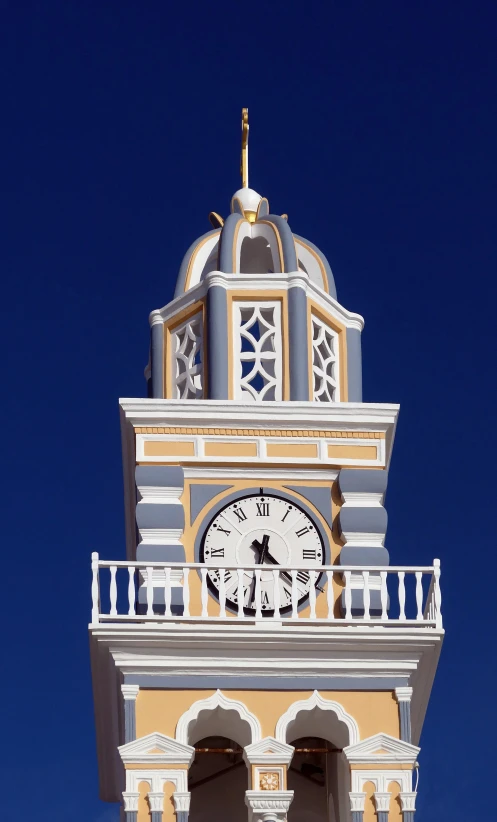 a clock tower with a white and orange top