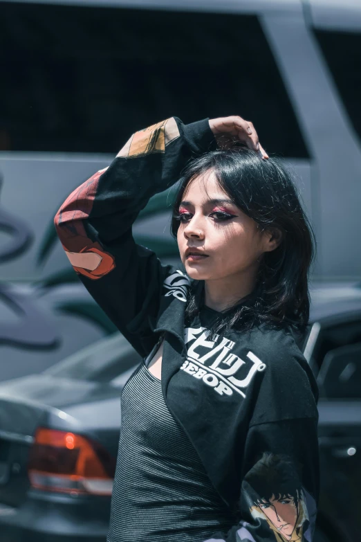 a woman is wearing a black shirt with a white and red design on it