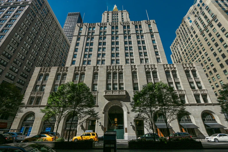 an elaborate building next to tall buildings in the city