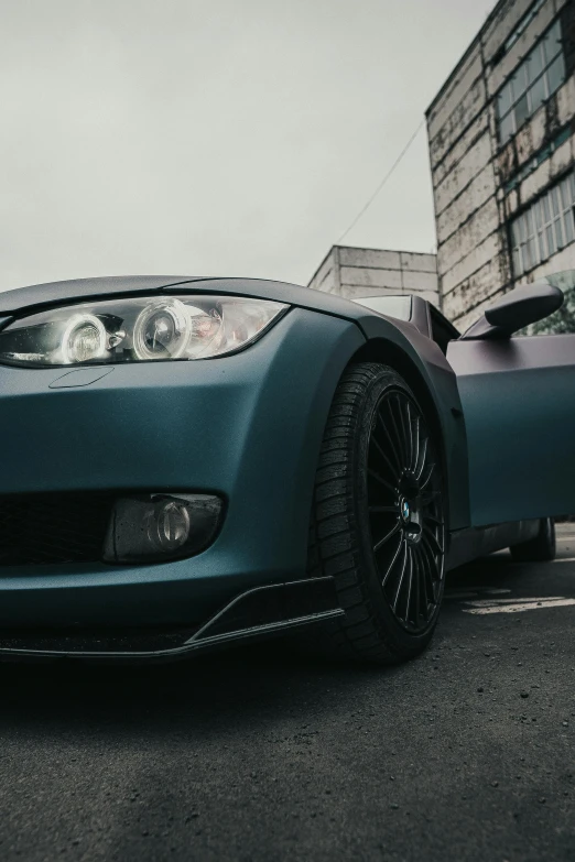 a dark blue car on the street is parked