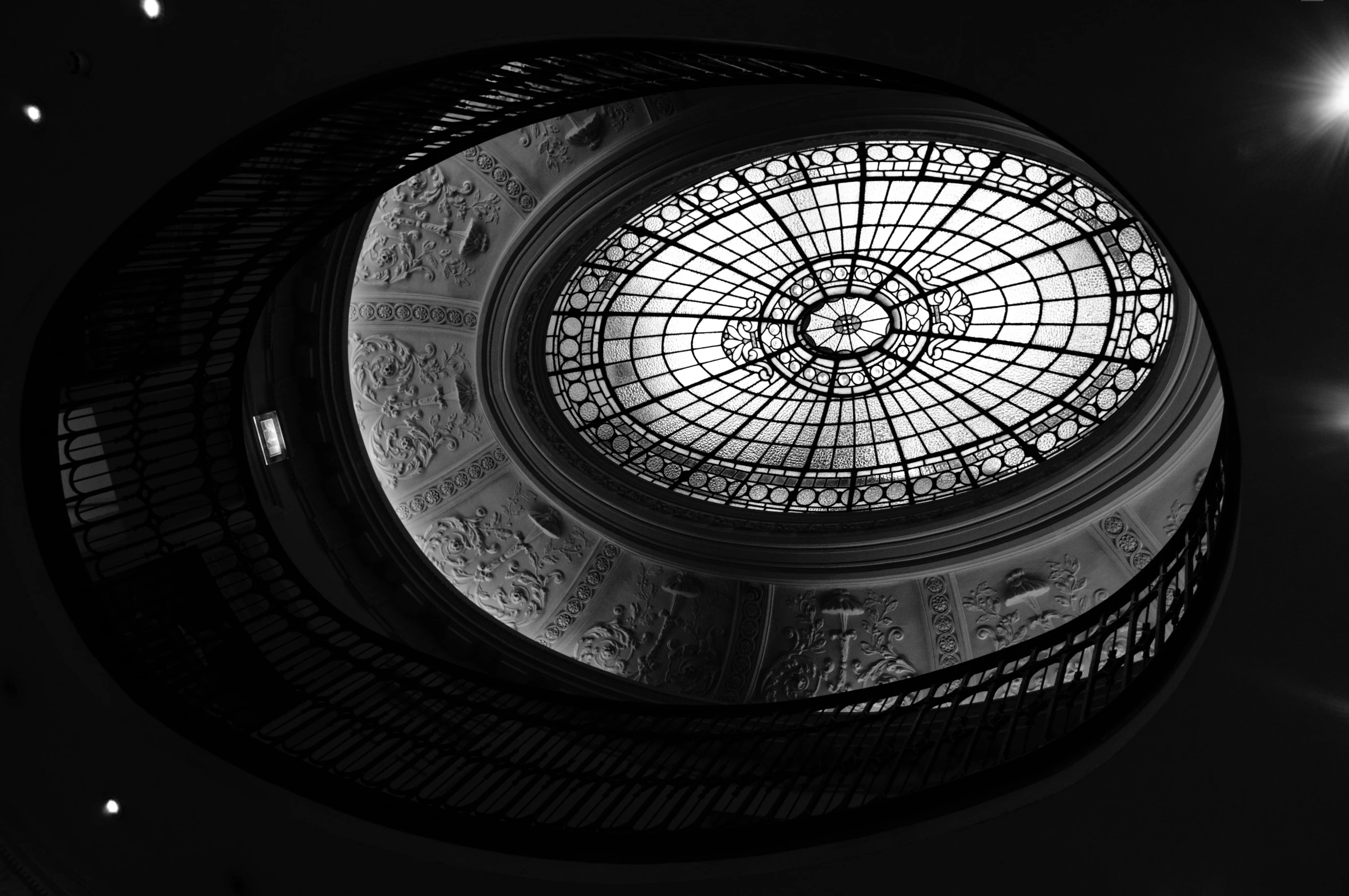 a spiral ceiling with lights in the middle