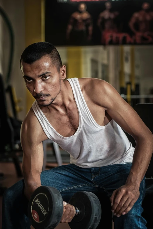 a man doing exercises with a dumbble on his knees