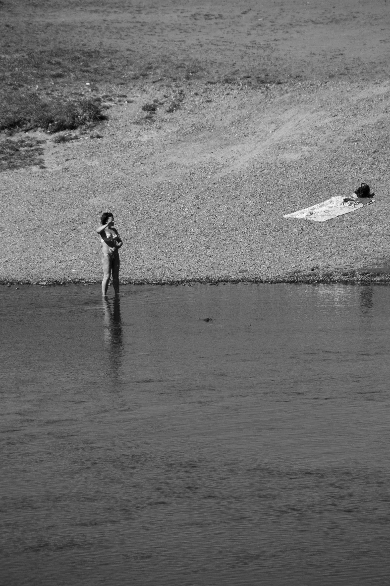 two people are in the water near the beach