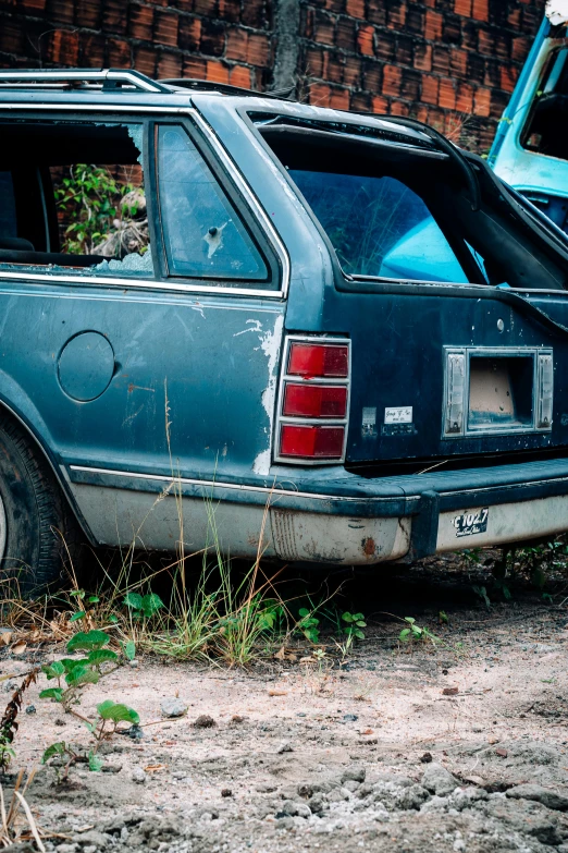 there is an old car and another broken down