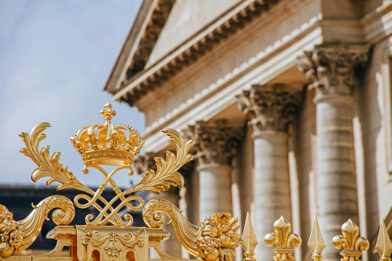 a golden decorative fence in front of a building