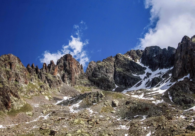 a mountain has snow and rock on it