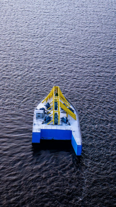 a small barge floating in the middle of the ocean