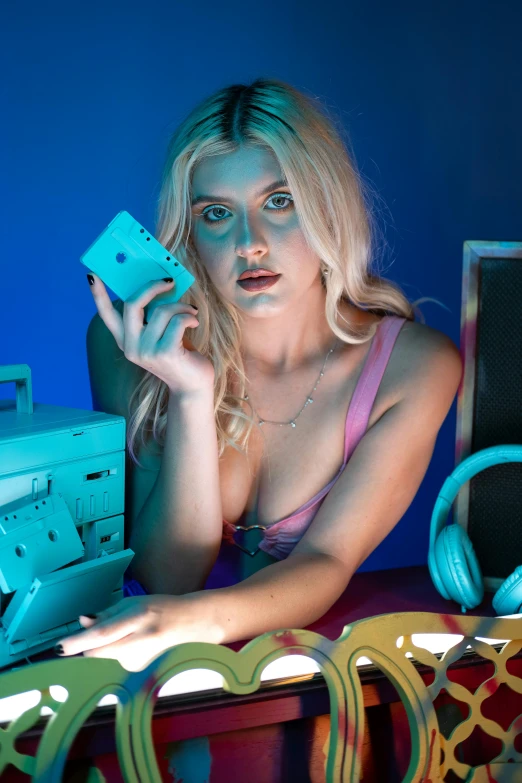 young woman sitting at a table with a video game controller in hand