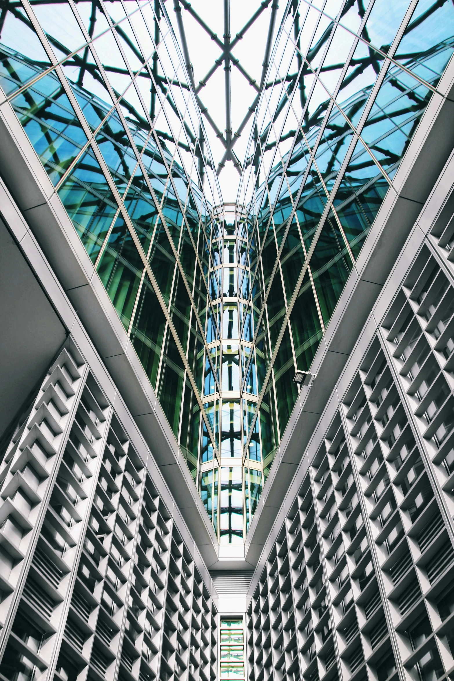 an atrium with many shelves under a blue sky