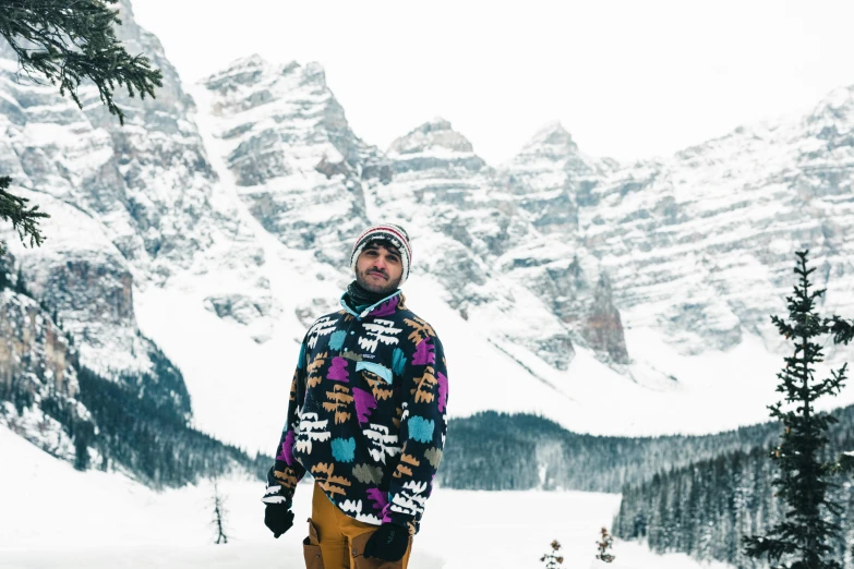 a person standing on top of a snow covered slope