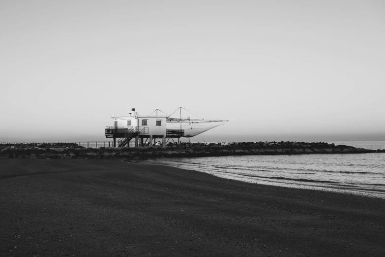 a boat is parked on the beach near the ocean