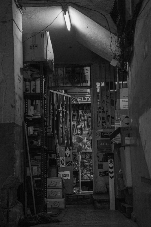 black and white image of store inside building with light coming through window