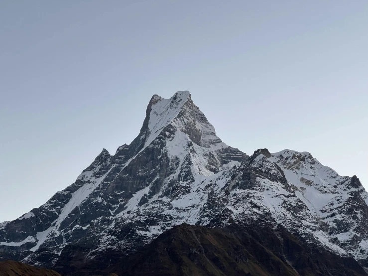 the tall snow covered mountains are against the blue sky