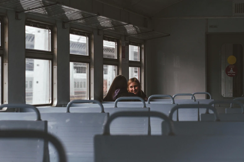 a woman looking through a window of a bus