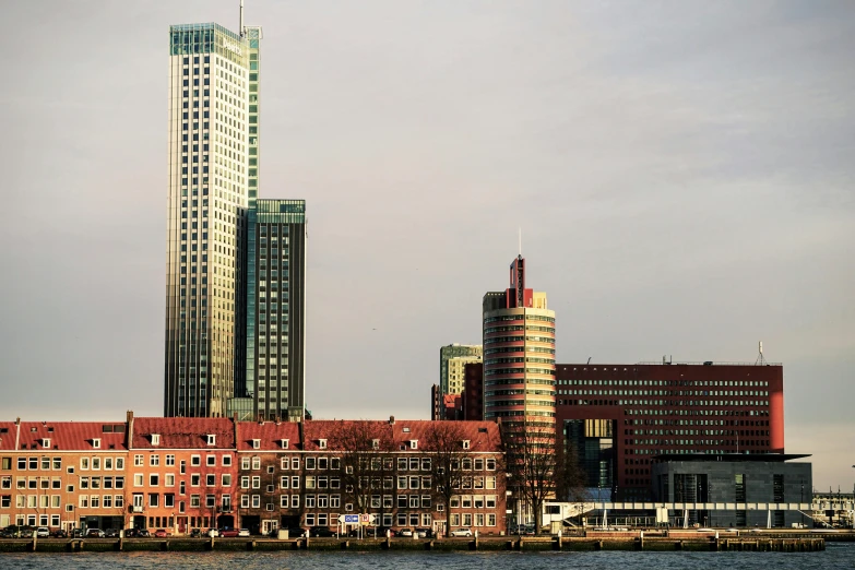 two large buildings next to water with one large building