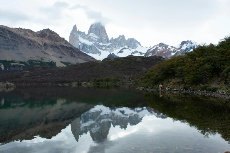 mountain reflected in a still lake as seen by a hiker