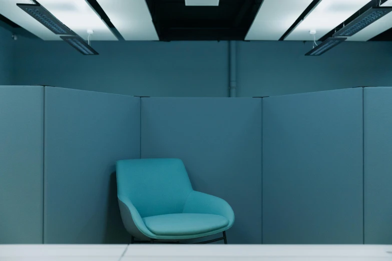 a blue chair sitting in the corner of a room