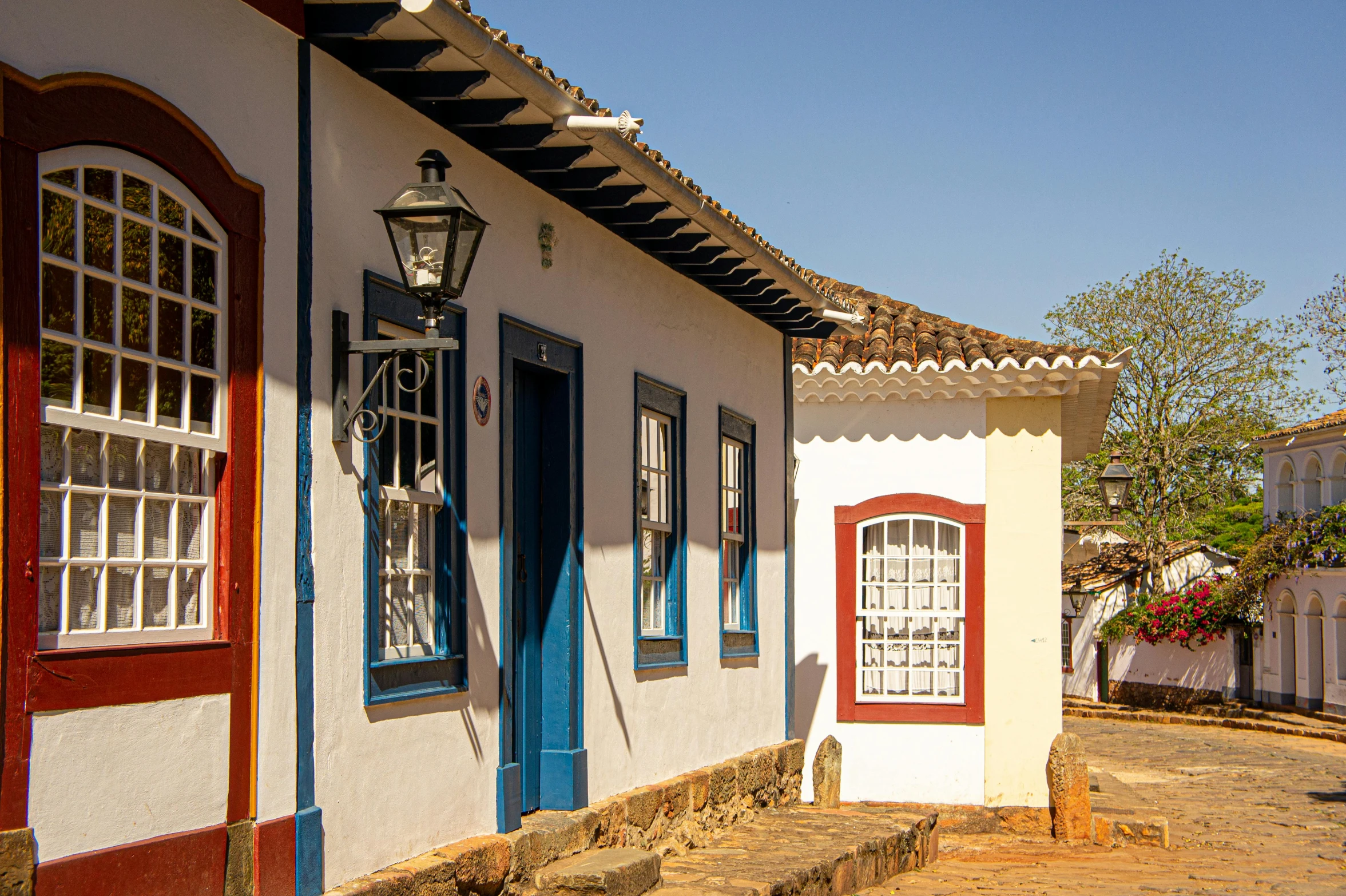 a small house with a window and a lamppost