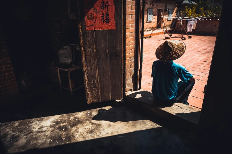 a person sitting on the step of a building