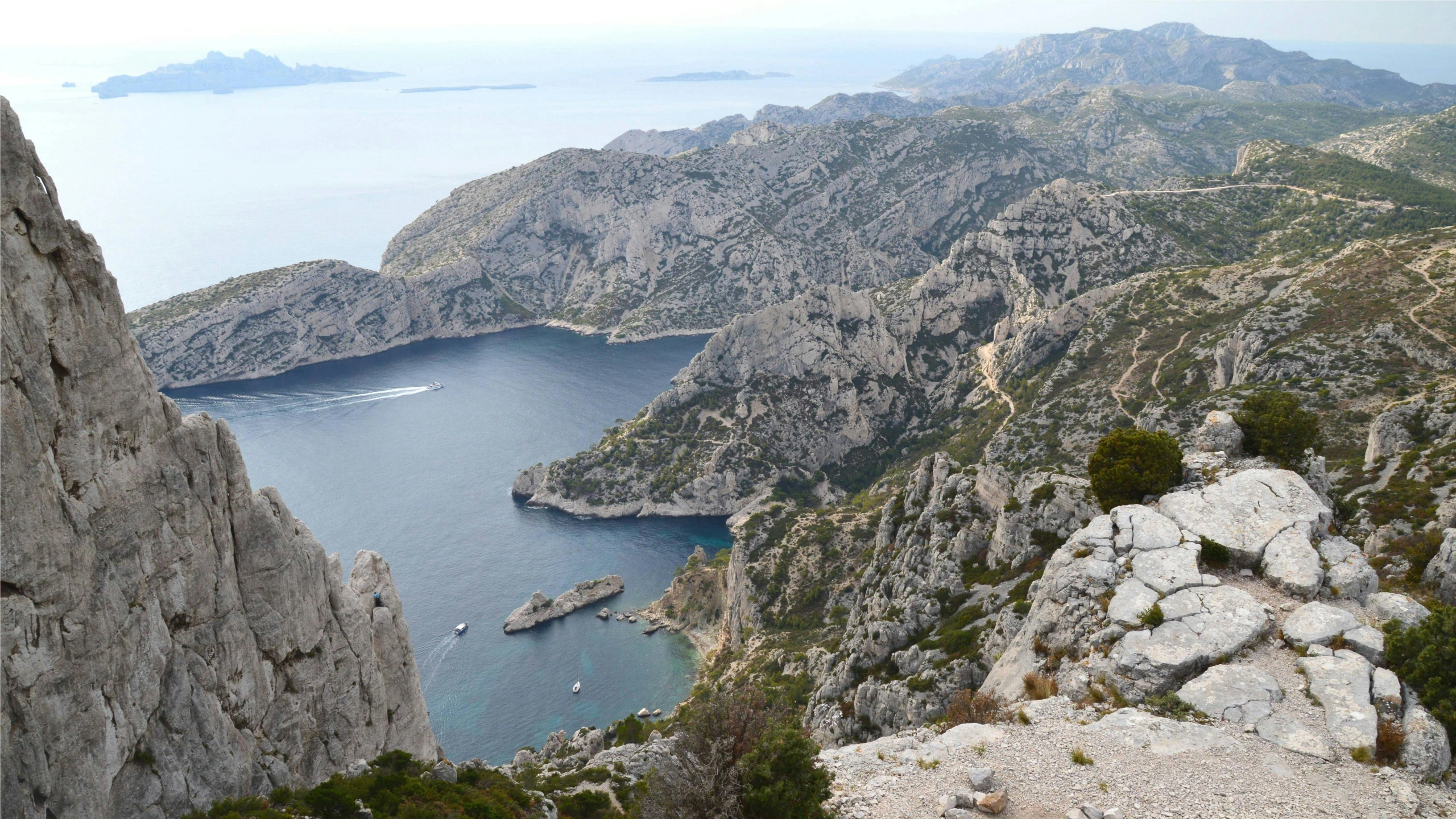 a large body of water between mountains with some rocks