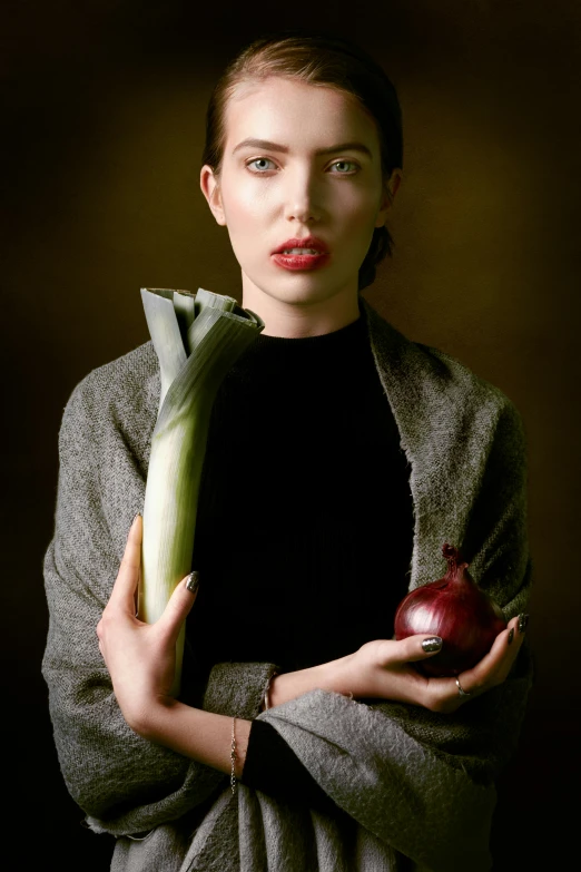woman holding an apple and looking at camera