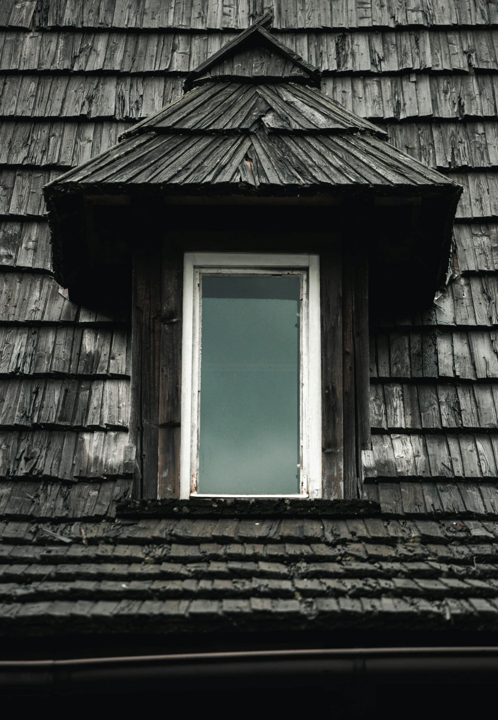 a small window on the side of an old house