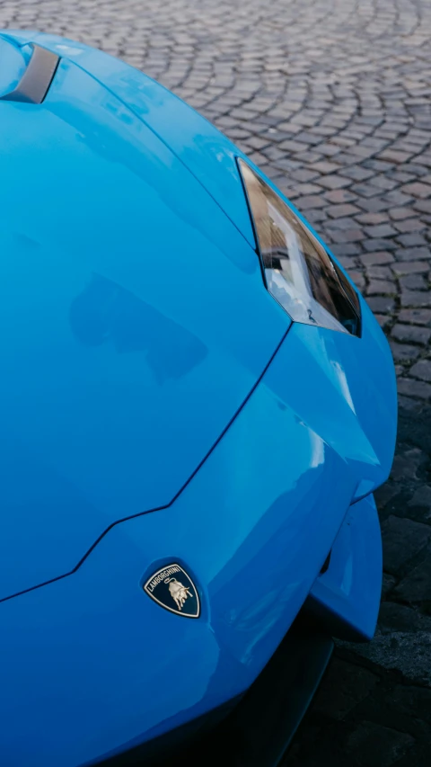 a blue sports car with chrome accents is shown