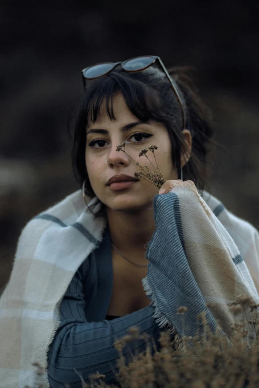 a girl with some flowers painted on her face and a sweater