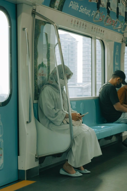 two people sitting on a bench with a cell phone