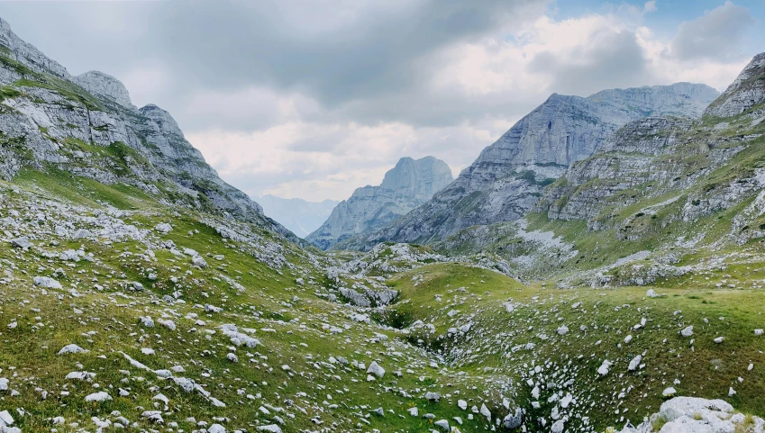 some green hills and some rocks on the ground